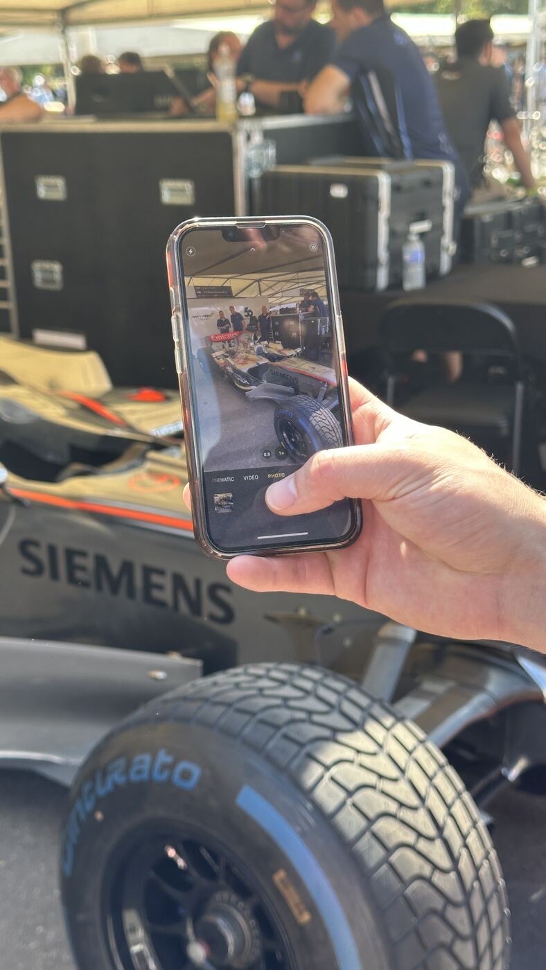 Phone held up to film a car at Goodwood Festival of Speed