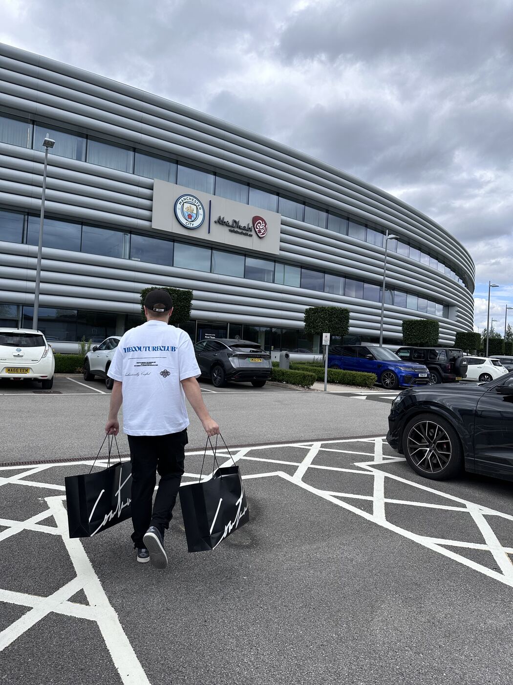 Matt carrying The Couture Club bags into Manchester City